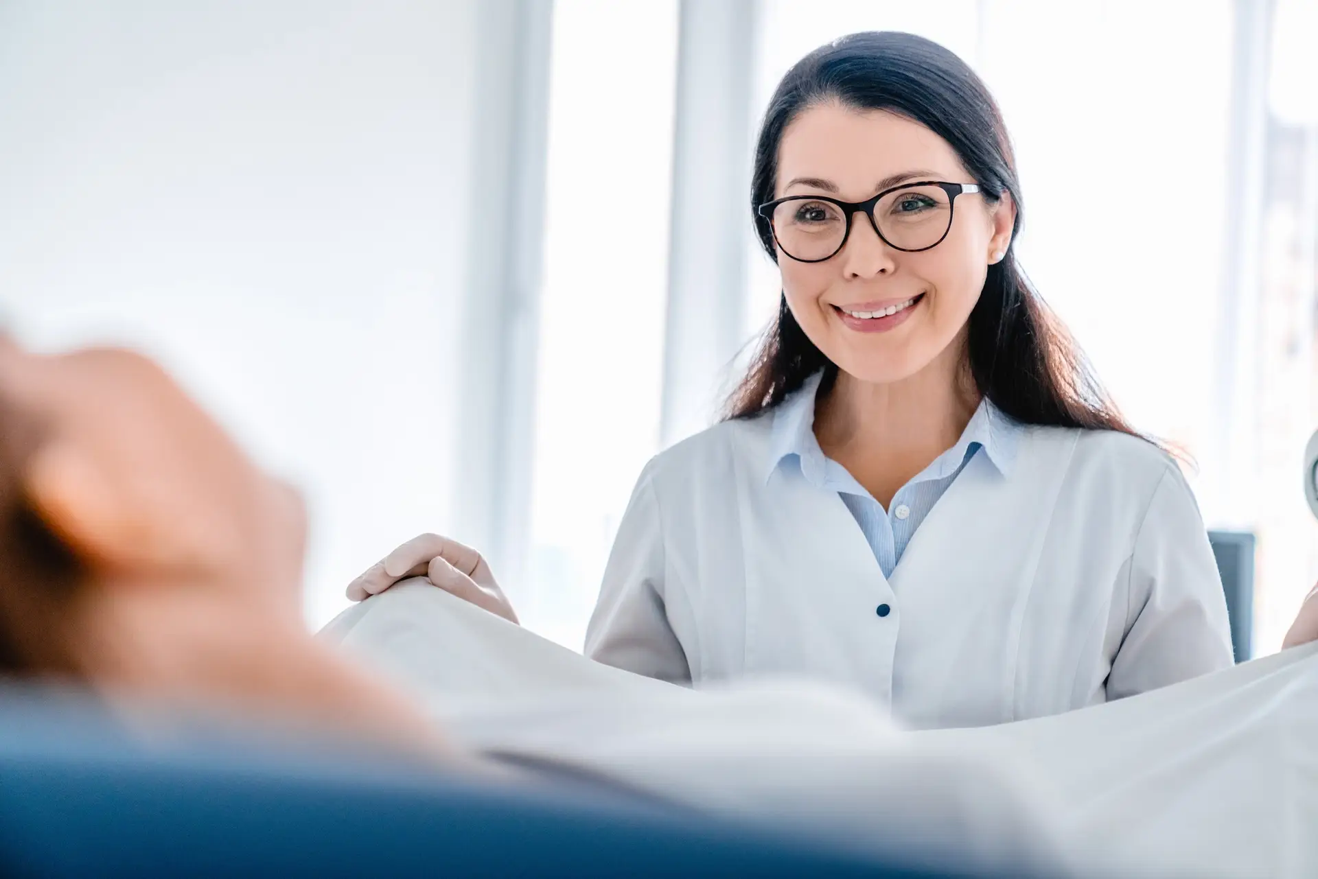 Female gynecologist working with patient in clinic
