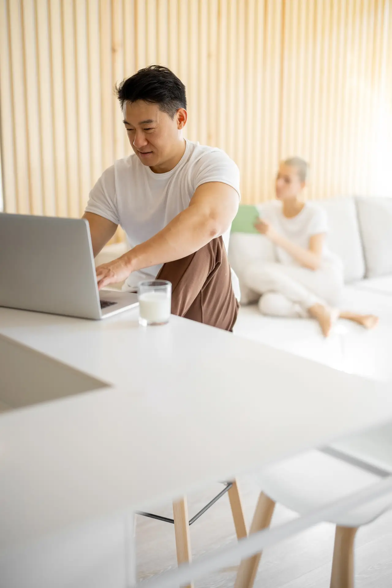 Multiracial couple using digital devices at home